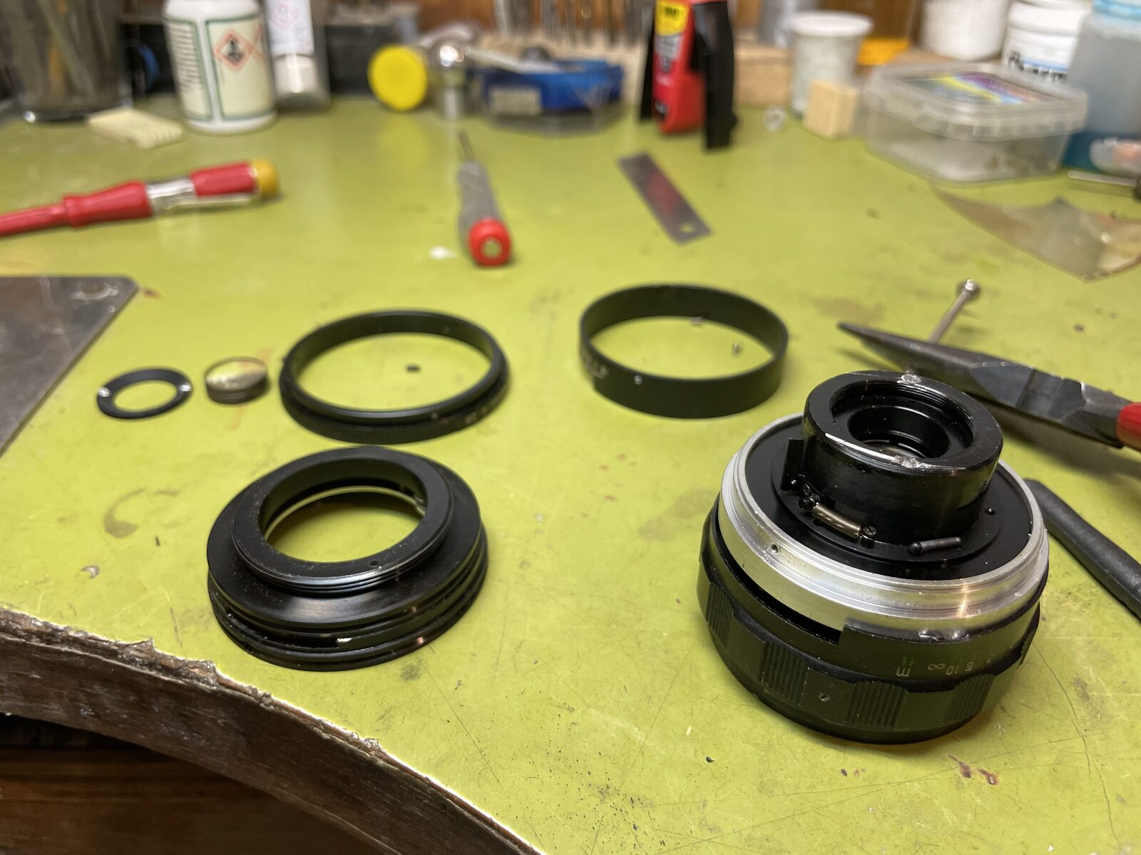 Lens taken apart into rings on the green bench
