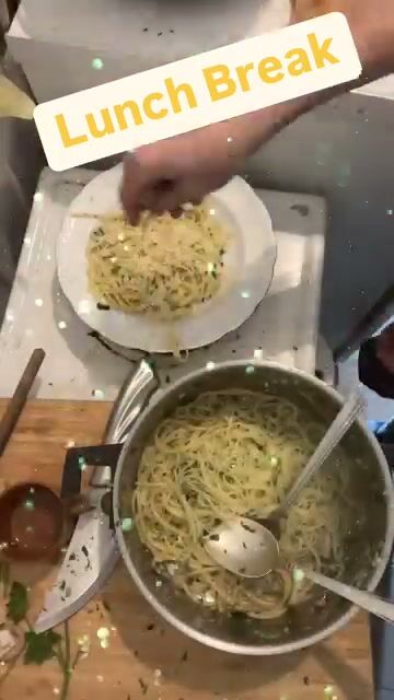 A pot of spaghetti and a plate on a chopping board