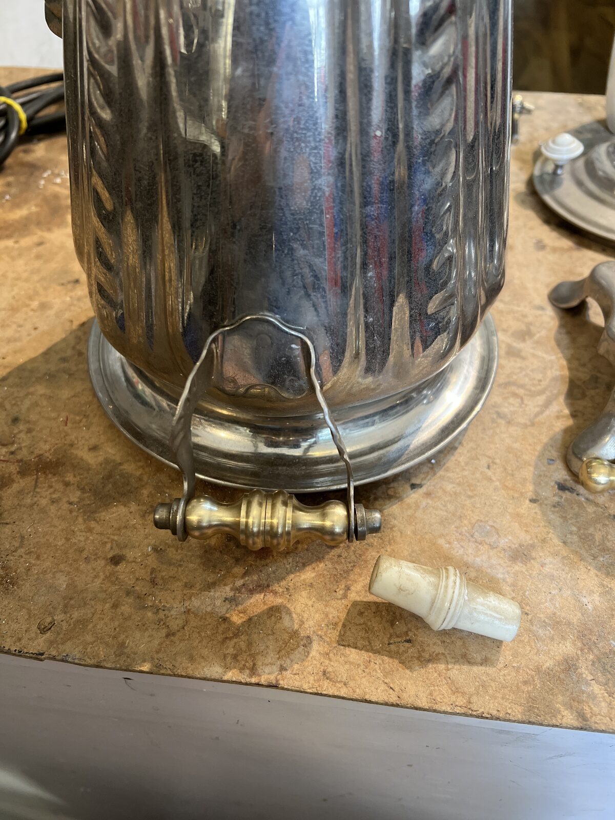Detail of the samovar foot and tap on the bench