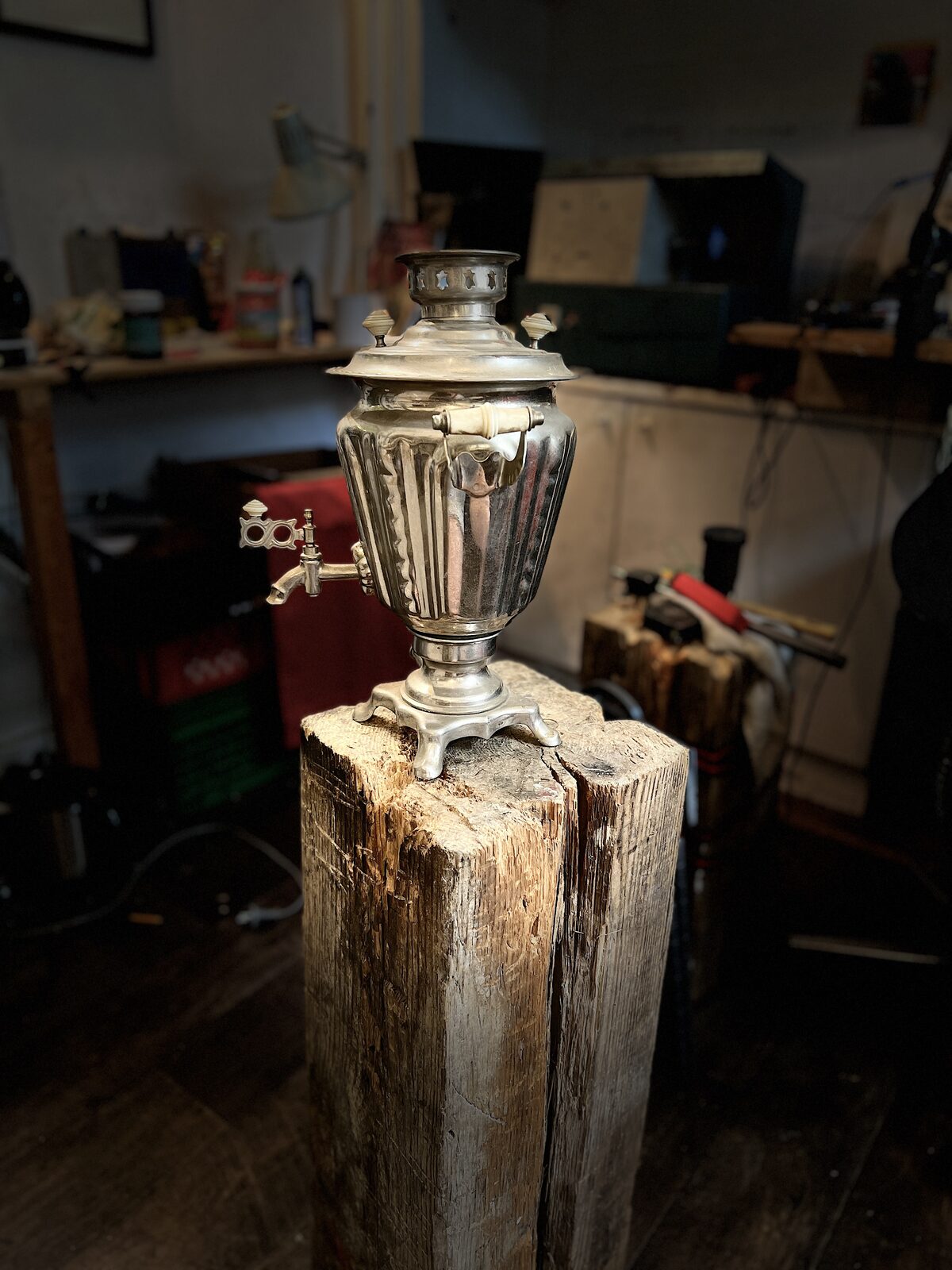 Samovar before: Nickel samovar whole on a stump in the workshop