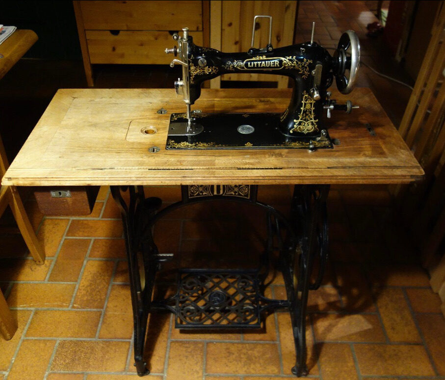 Sewing Machine Lamp before: Littauer treadle sewing machine complete on its table, at home