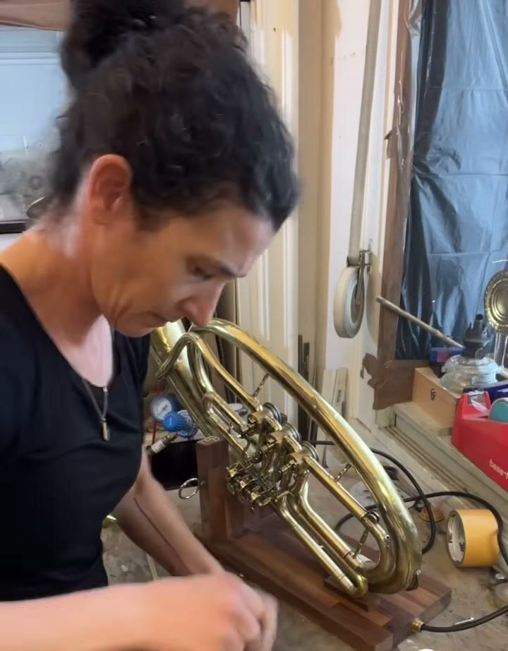 Keren at her bench, testing the Tuba lamp