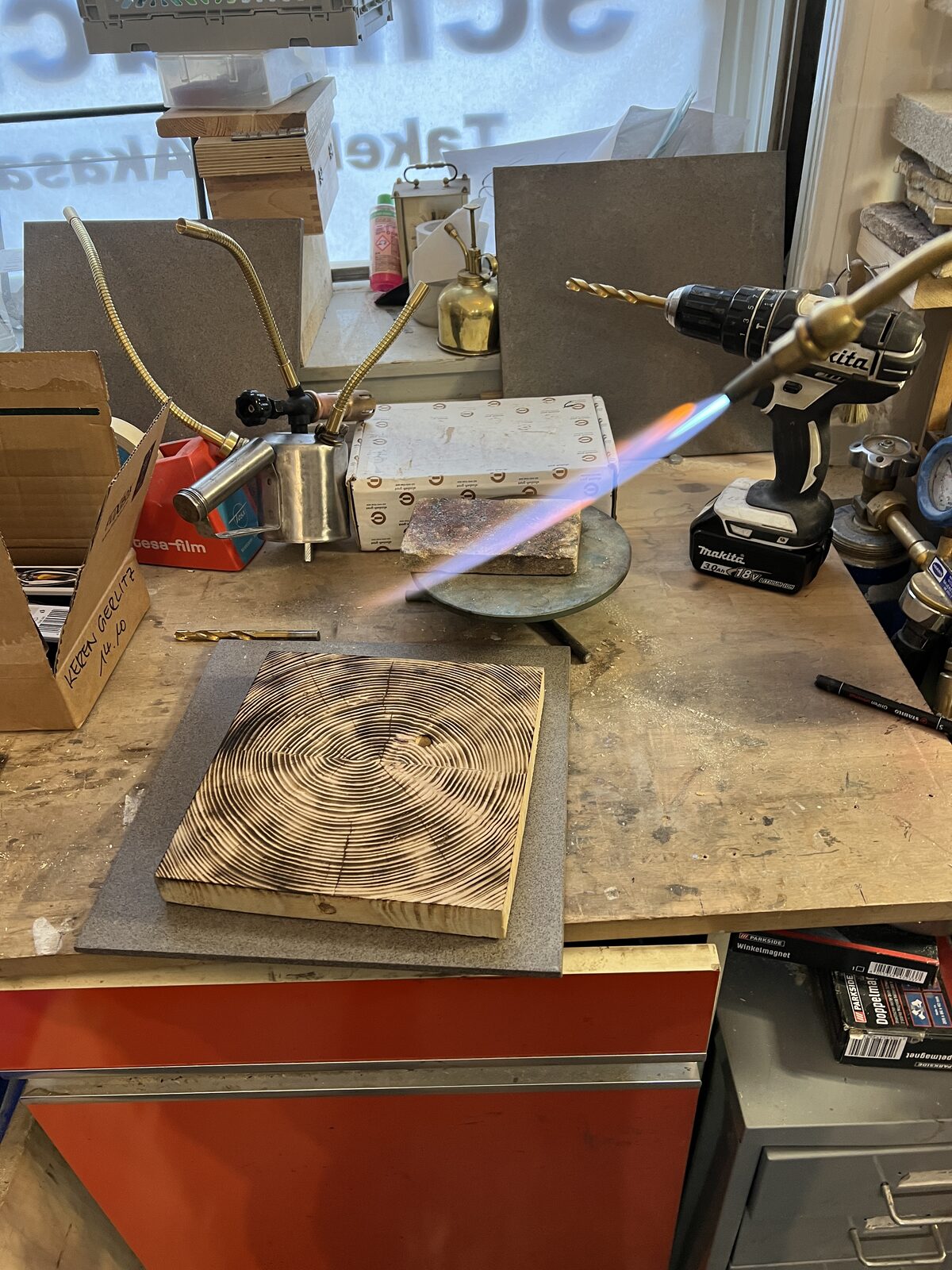 Soldering with the torch flame at the bench