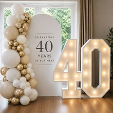 Light-up number display with personalised sailboard and balloon styling for a milestone anniversary