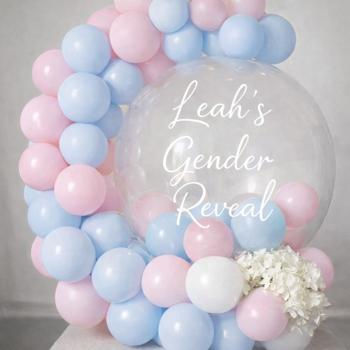 Personalised gender reveal balloon hug display in pale pink and blue with white “Leah’s Gender Reveal” vinyl.