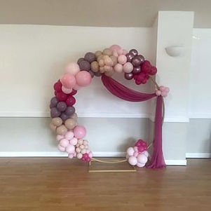 Balloon hoop backdrop styled for an engagement celebration