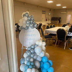 Personalised religious welcome sign and easel with coordinating balloon decoration.