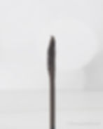 Close-up of a mascara wand with a unique tapered brush, set against a soft white background. "© kbeautyhobbit.com" is visible.