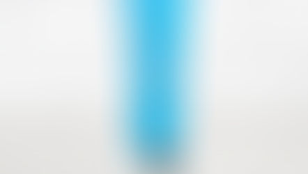 A blue lip serum tube labeled "fwee" on a speckled countertop with a white tiled background.