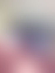 Sunlit bed with a lavender Omnia pillow on pink bedding, against a white headboard; watermark kbeautyhobbit in corner.