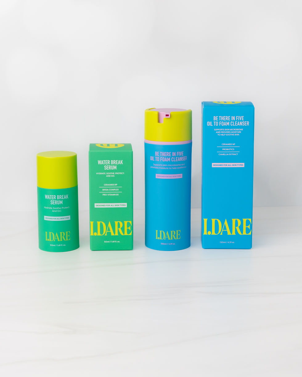 Four colorful I.DARE skincare product packages on a white background, including Water Break Serum and Oil to Foam Cleanser.