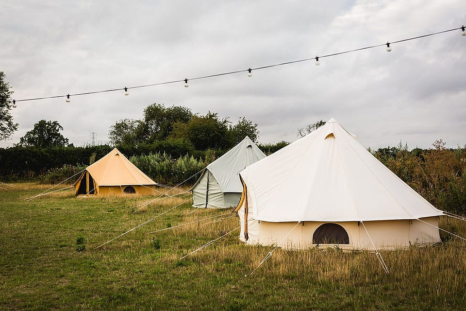 Bell tents set up for wedding reception guests at BrackenXcapes