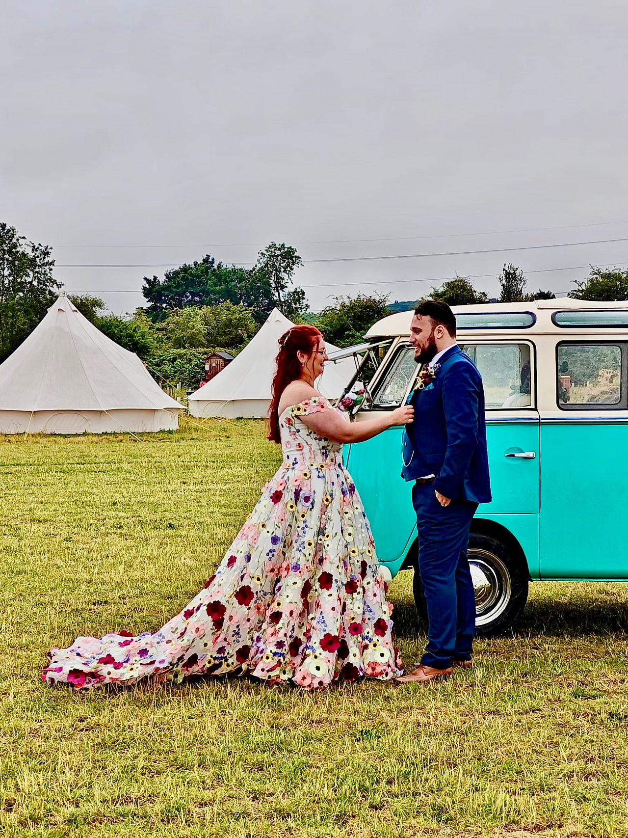 Nathan and Kirsty in front of an RV at their wedding reception at BrackenXcapes