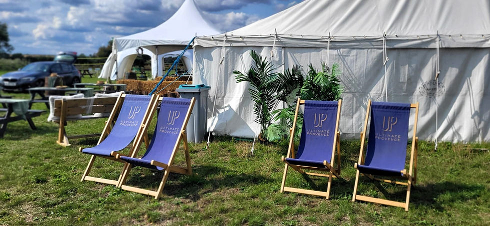 Deck chairs and marquees at BrackenXcapes glamping site for a wedding reception