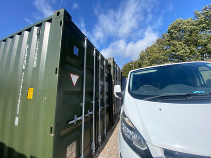 van next to a green ISO shipping container