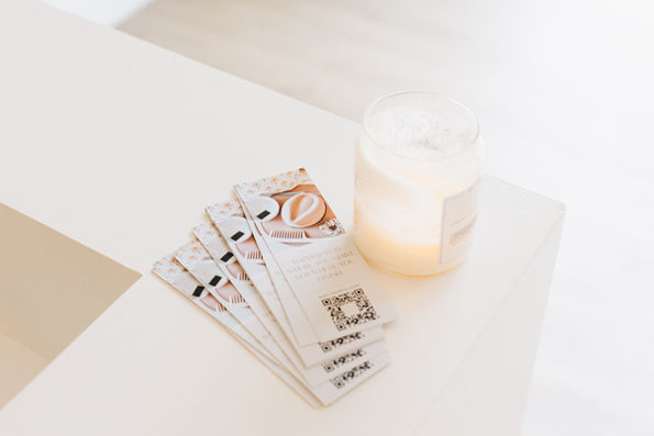 mane and magnolia branded bookmarks and candles