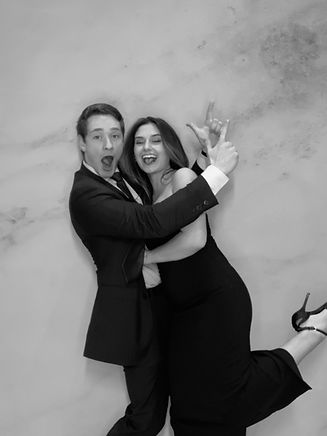 Wedding guests are taking a playful photo booth picture together.