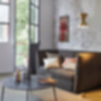 Aureole brass pendant mood shot; warm ambient glow over seating