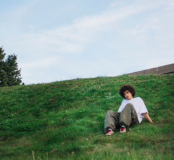 Photo of me sitting on a hill.