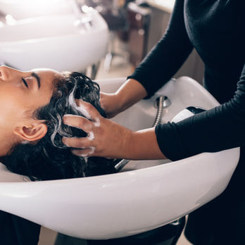 stylist shampooing hair