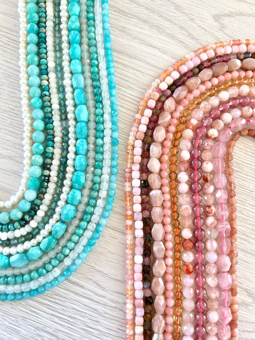 selection of beautiful gemstone bead strands in hues of turquoise, green, pink, cream and orange