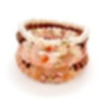 bracelets stacked made from pearls, peach moonstone, sakura agate and sandalwood