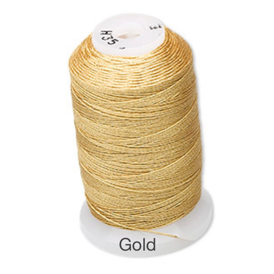 Thumbnail: spool of gold coloured silk thread size E