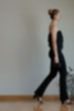 Tall woman wearing long black flared pants, walking left -Miss G & Me - Clothes for Tall women