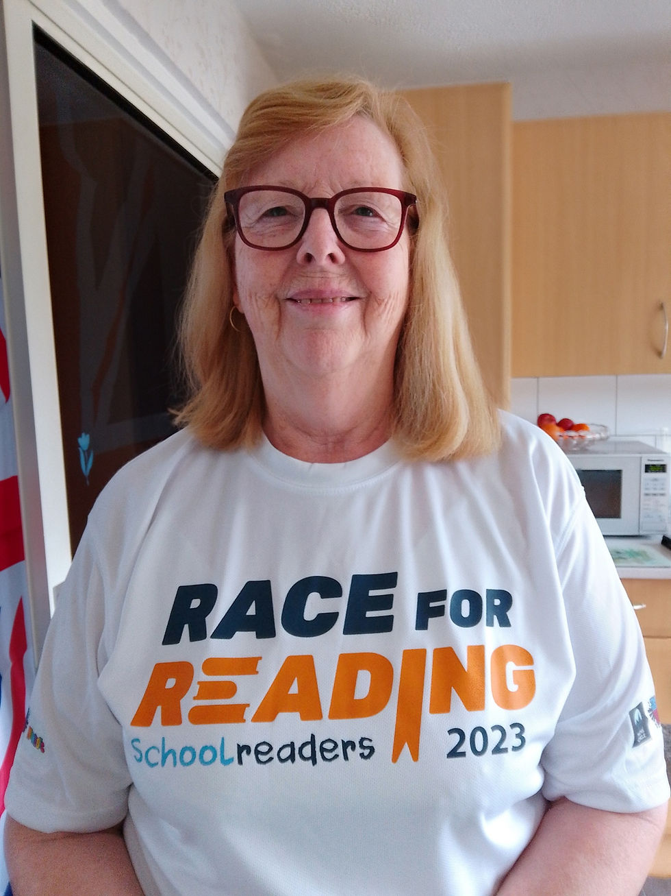 A lady wearing a Race for Reading T-shirt