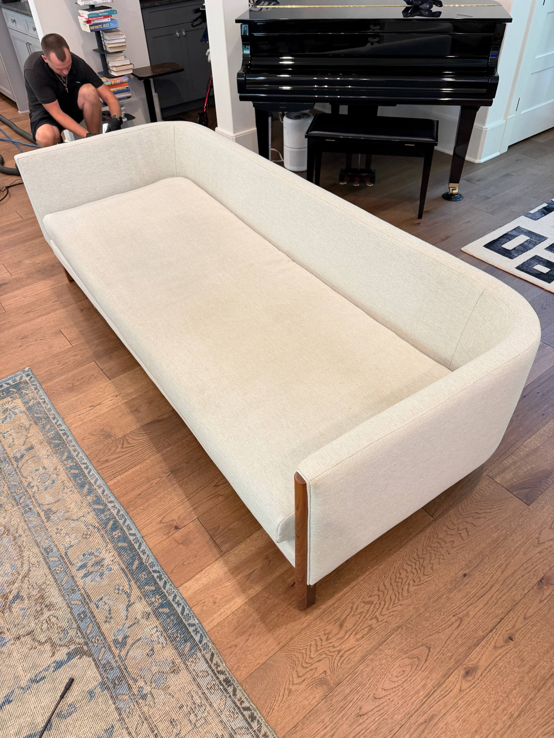 Modern beige sofa being professionally cleaned in a home in Huntersville, NC