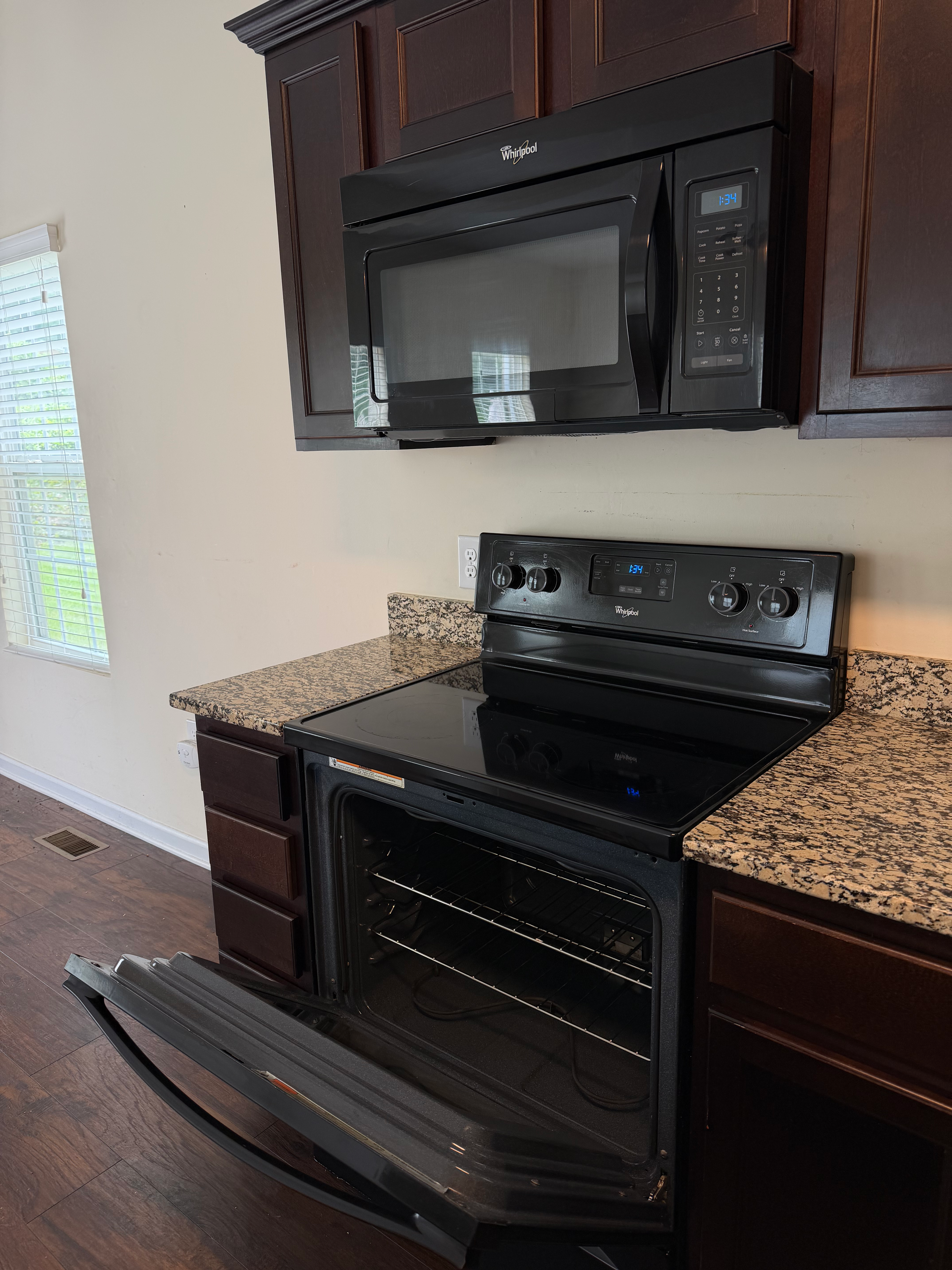 Black Whirlpool microwave and glass-top oven in kitchen in Davidson, NC