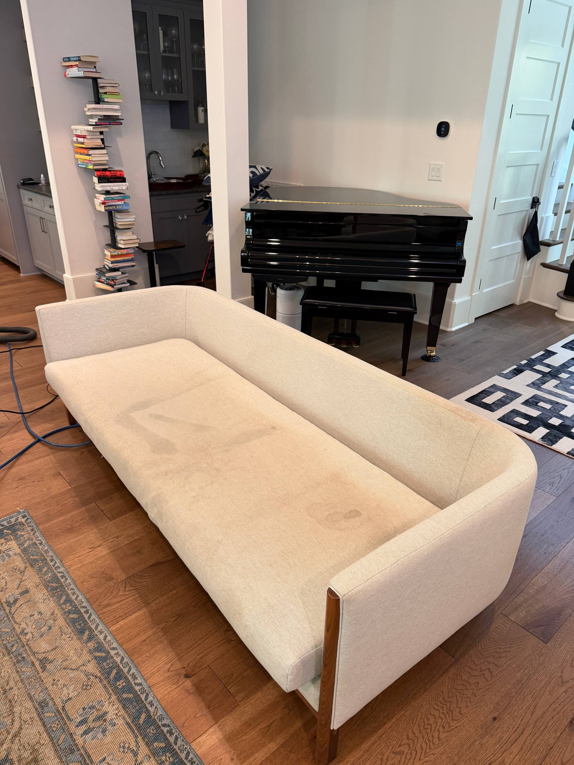 Stained beige sofa in a room with a black grand piano in Mooresville, NC