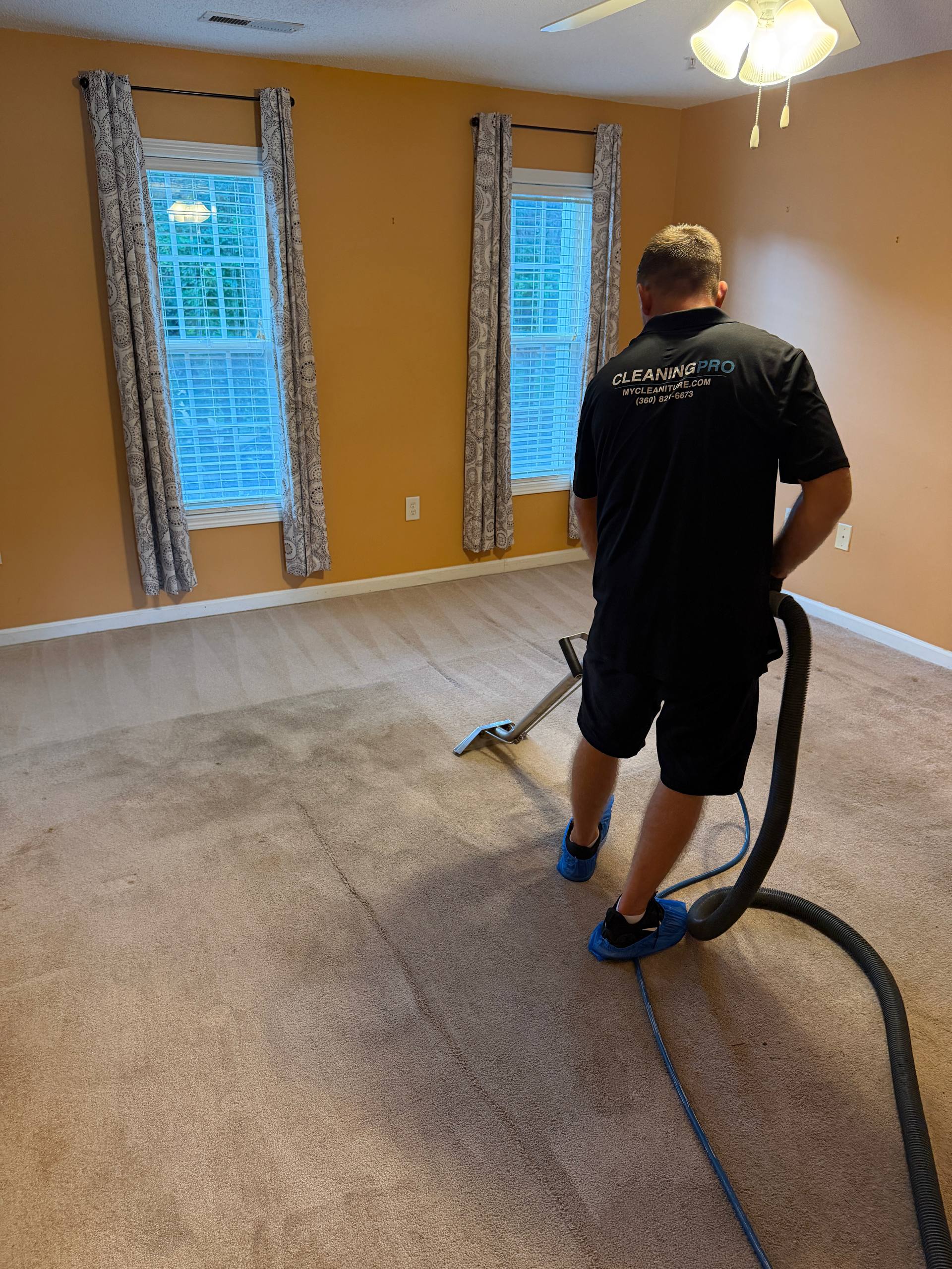 Professional steam cleaning a beige carpet in Huntersville, NC
