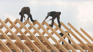 Roofing contractor working safely at height under Gaylord Insurance coverage.