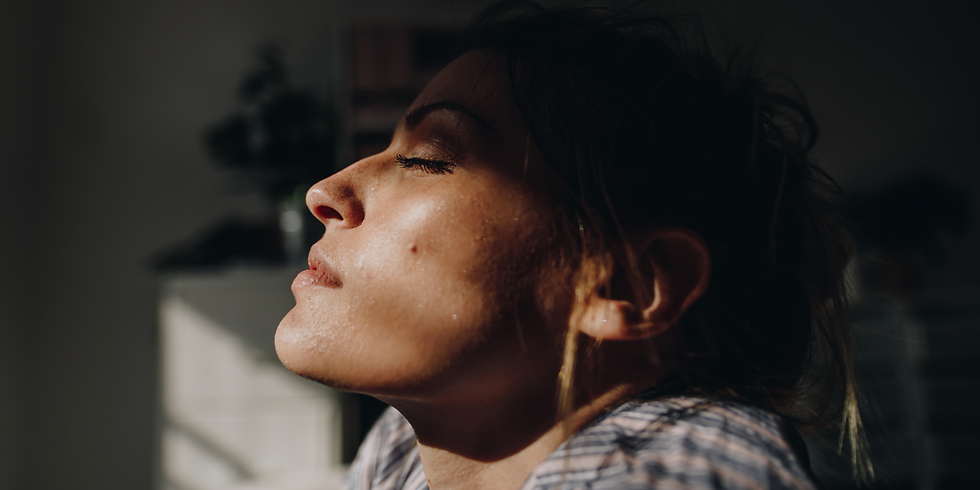 Profile of woman with eyes closed, focusing on her senses to reduce anxiety.