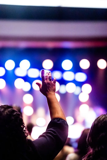 photo-of-a-woman-raising-her-hand-prayer-worship-church-lights-caleb-oquendo-pexels-104712