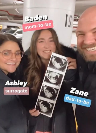 Group of adults with a sonogram photo