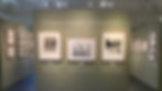Gallery entrance wall titled "Convergence & Divergence: The Family Aesthetic," with three framed works hung side by side beneath the artists' names — Roi Partridge, Imogen Cunningham, and Rondal Partridge. Sections labeled "Exploring the Medium" and "Shared Vision" are visible on the flanking walls.
