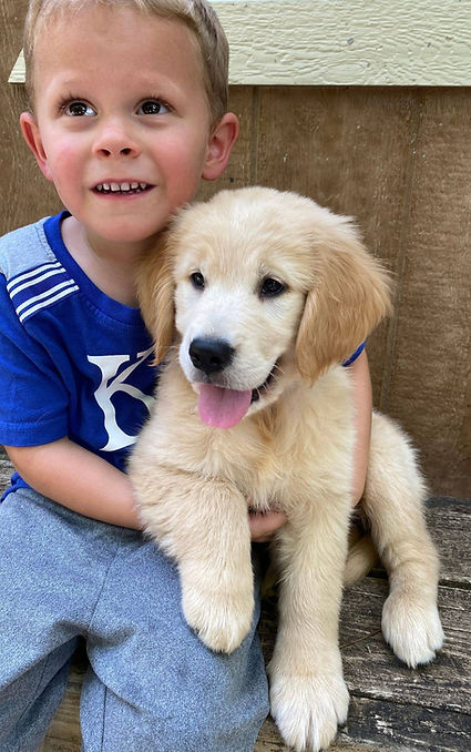 John holding a Golden Retriever puppy
