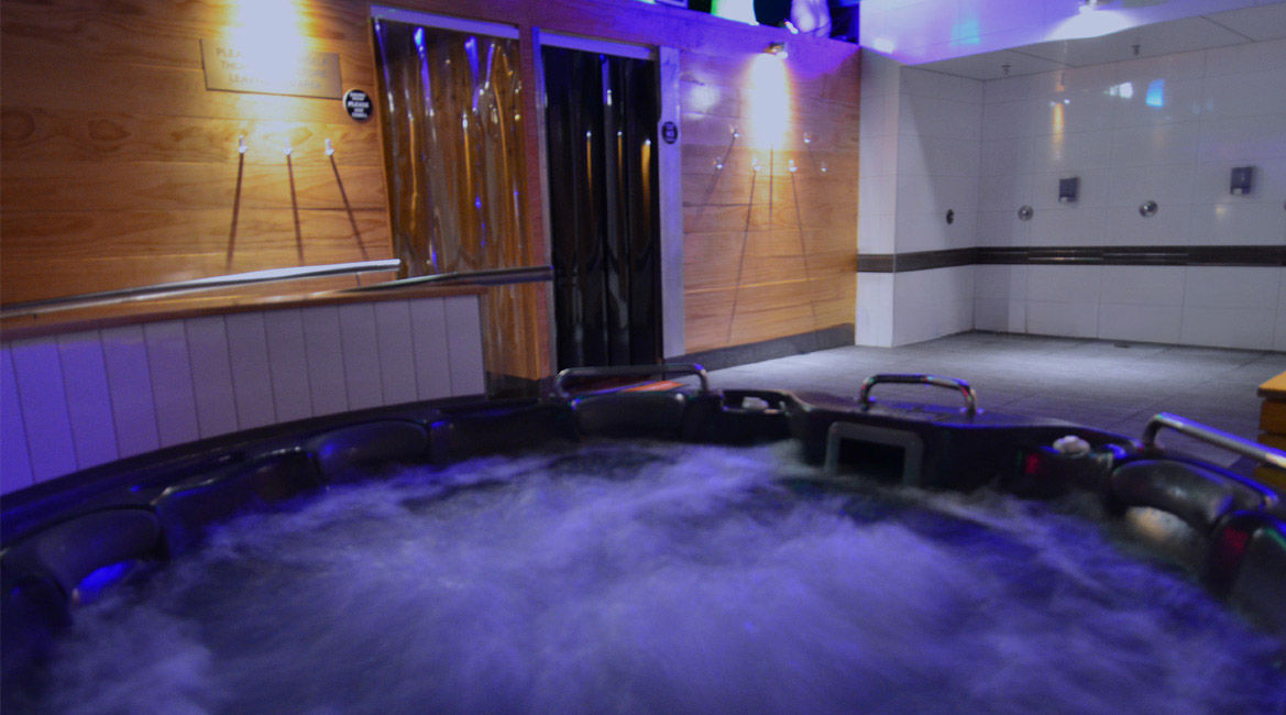 Bubbling spa pool and shower area at Menfriends