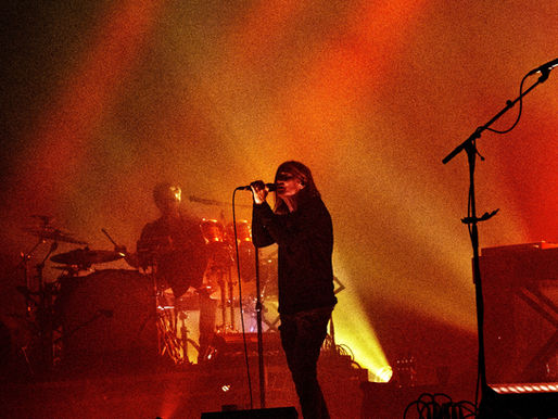 Beth Gibbons performing at Fortitude Music Hall, surrounded by smoke and soft red lighting.