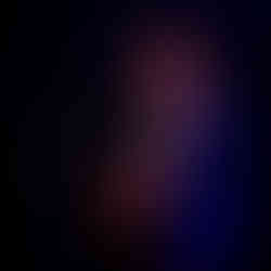 Paul Dempsey standing alone in a white spotlight, singing into a microphone while strumming an acoustic guitar before the glorious QPAC Concert Hall