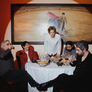 Spoon at dinner in a promo photo for 2025