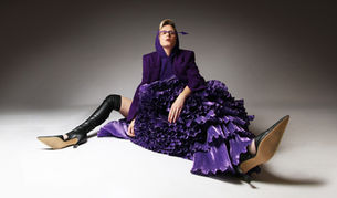 Róisín Murphy POSES FOR A PROMO PHOTO IN KNEE-HIGH BOOTS AND A RUFFLED PURPLE DRESS