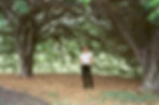 Singer, writer and producer, Ben Provest stands in leaves under a tree
