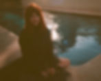 Sydney alt-pop artist Jordan Laser sitting next to a pool looking pensive