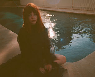 Sydney alt-pop artist Jordan Laser sitting next to a pool looking pensive