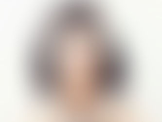 A female artist called Ladi Abundance posing for a promo pic, her face covered in jewels
