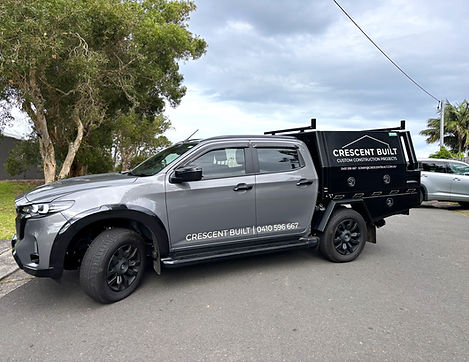white vinyl lettering on grey and black work ute