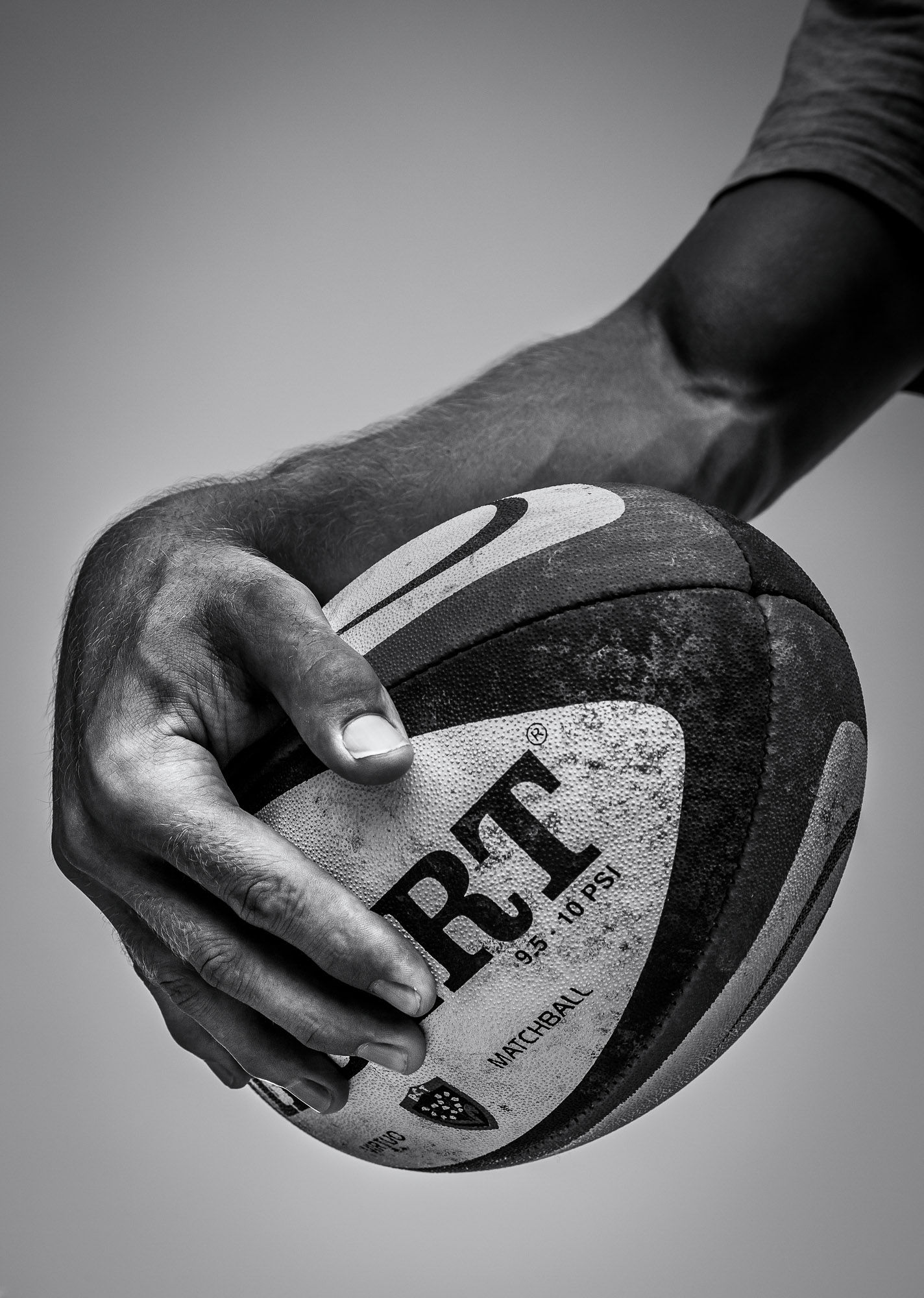 The hands of Jonny Wilkinson holding a rugby ball